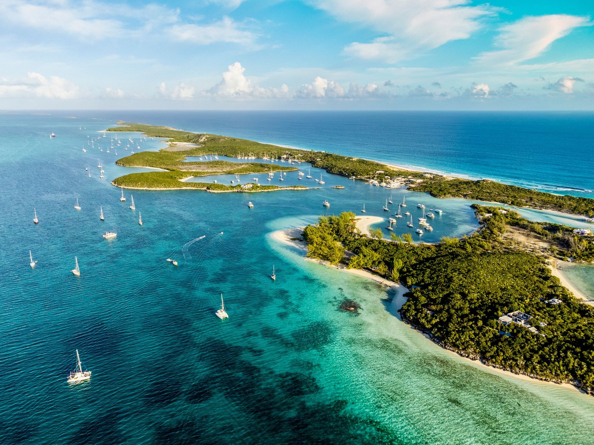 An aerial view of a tropical island in the middle of the ocean.