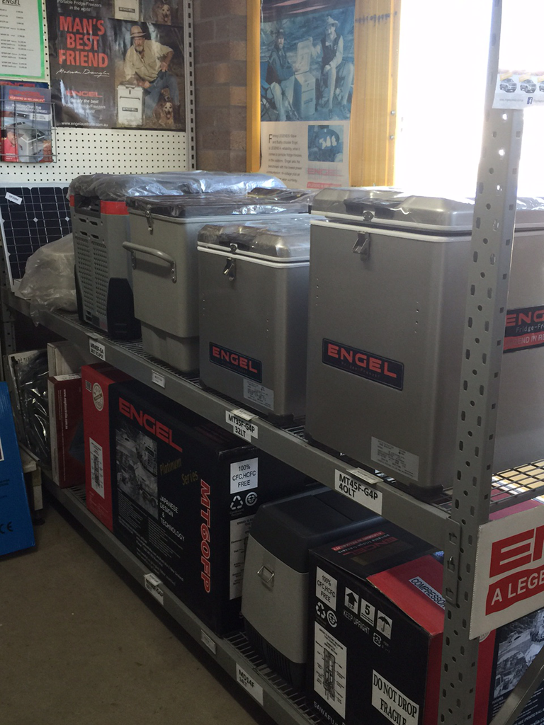 Store Shelf With Silver Engel Portable Fridges and Black Esky Coolers — PowerMaster Batteries Moree in St, Moree, NSW