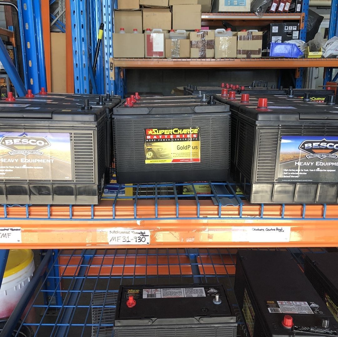 Shelf of Car Batteries in a Warehouse, With Black and Gray Batteries — PowerMaster Batteries Moree in Narrabri, NSW