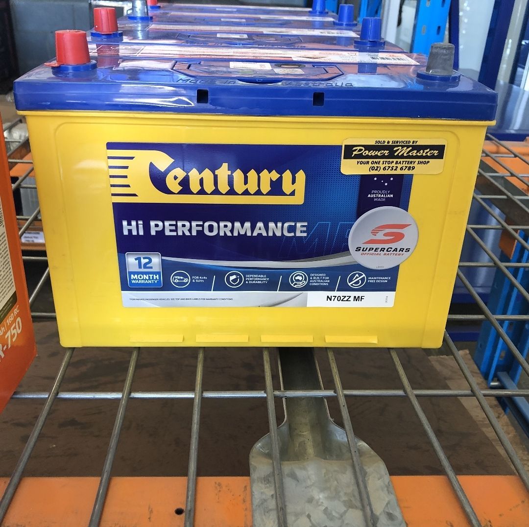 Yellow Century Hi Performance Car Battery With Blue Top on a Store Shelf — PowerMaster Batteries Moree in Walgett, NSW