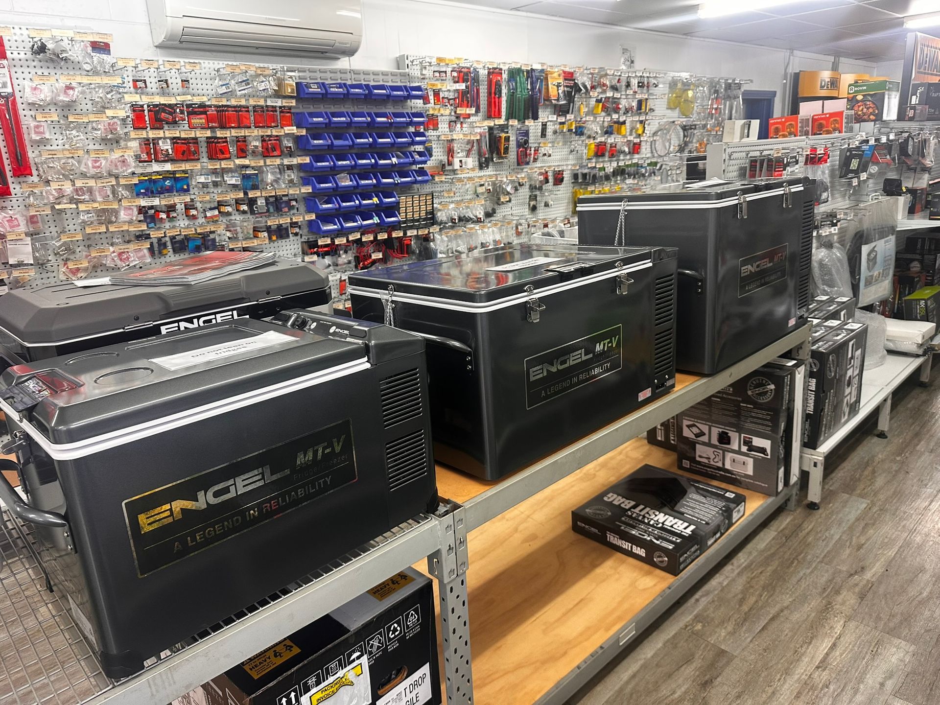 Store Aisle With Three Black Battery Units on Display Shelves — PowerMaster Batteries Moree in St, Moree, NSW