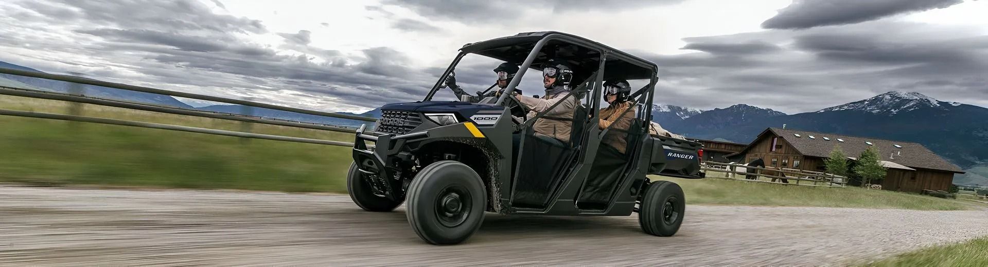 Black Off-road Side-by-side Driving on a Dirt Road With Mountains — PowerMaster Batteries Moree in Goondiwindi, NSW