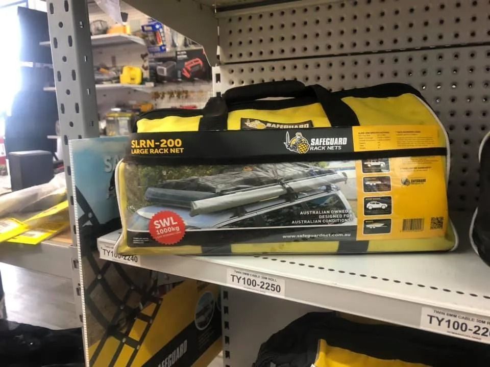 Yellow and Black Tool Bag on a Store Shelf With Boxed Metal Parts Behind It — PowerMaster Batteries Moree in St, Moree, NSW