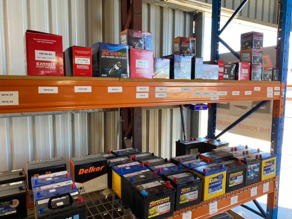 Shelves of Assorted Car Batteries in Red, Black, and Yellow Boxes — PowerMaster Batteries Moree in St, Moree, NSW