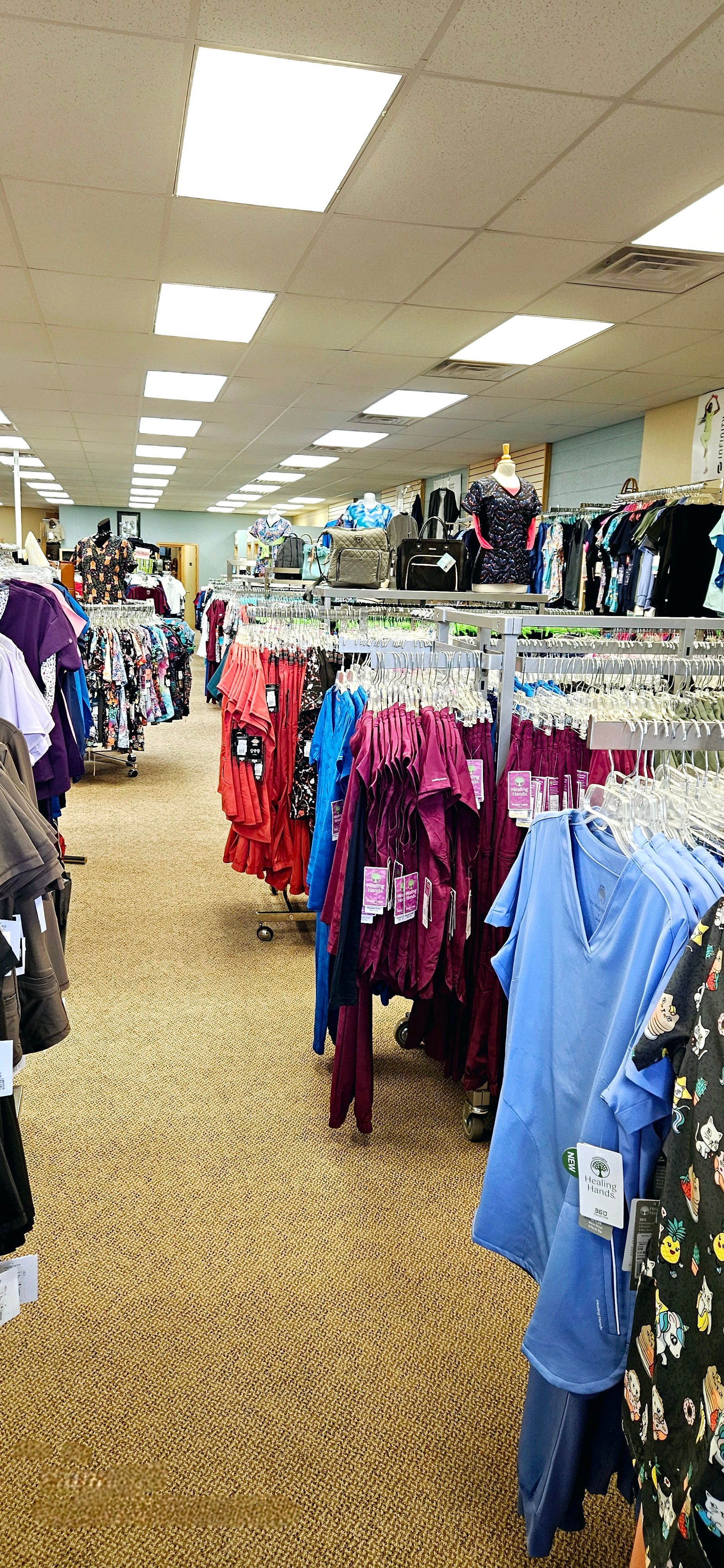 A store filled with lots of clothes hanging on racks.