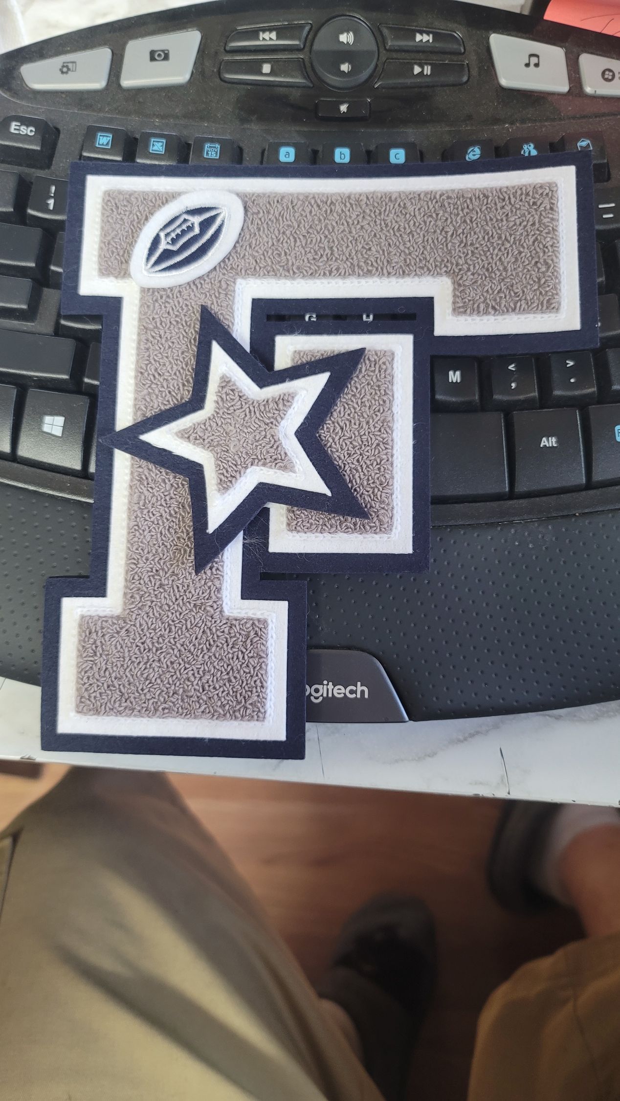 Royal blue and silver college varsity jacket with university crest patch