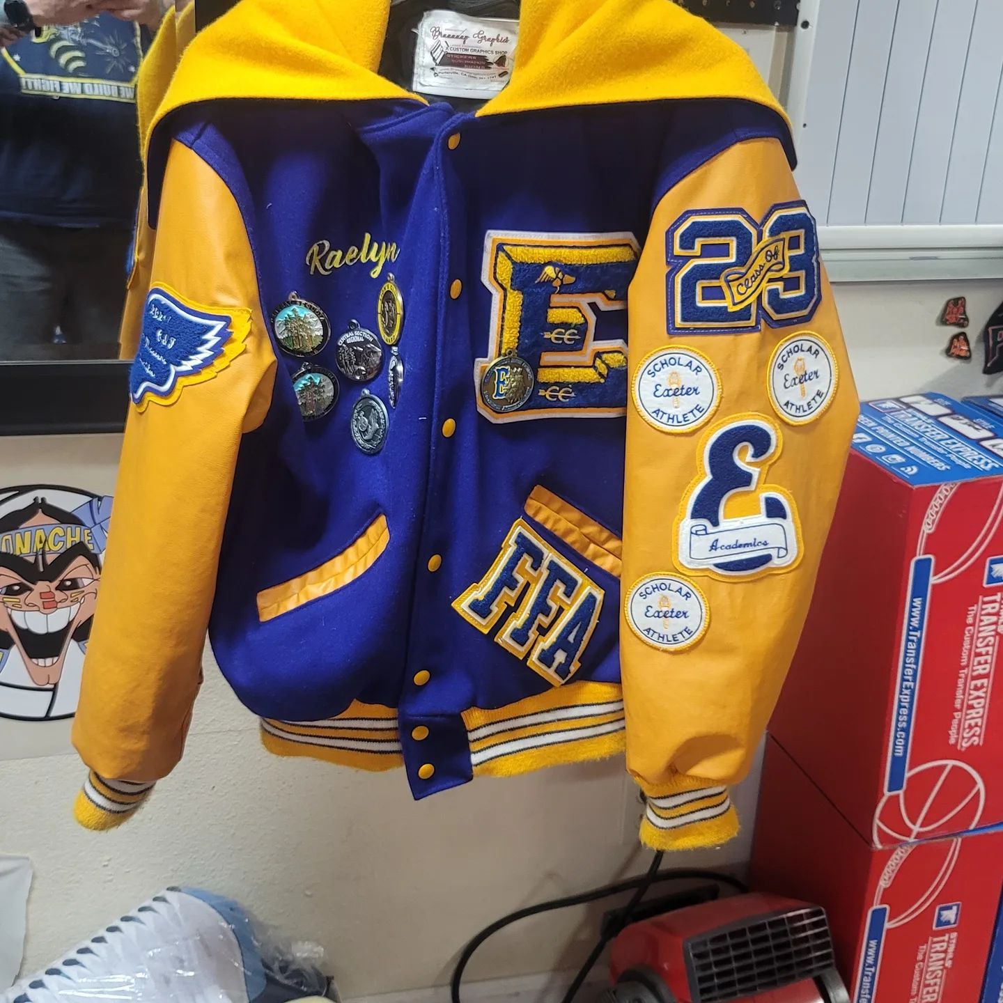 Navy and gold varsity football jacket with chenille patch and number 23