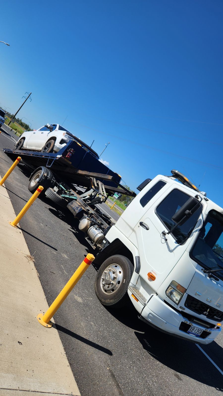 A Tow Truck Is Carrying A Car That Has Been Involved In A Car Accident — Rockhampton Towing And Transport in Gracemere, QLD