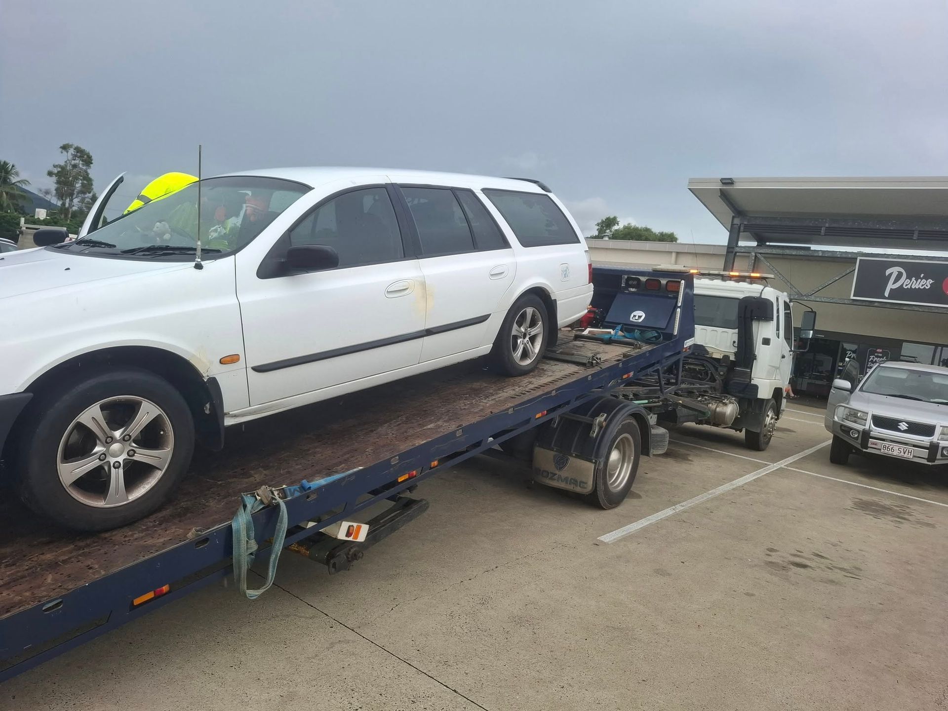 A Tow Truck Is Towing A Car  — Rockhampton Towing And Transport in Gracemere, QLD