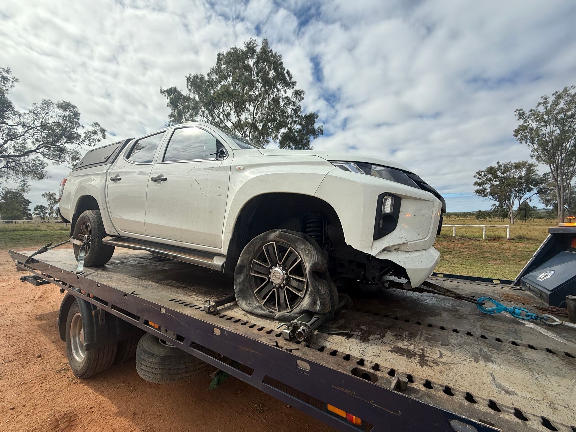 A Red Car Is Being Towed By A Tow Truck — Rockhampton Towing And Transport in Blackwater, QLD