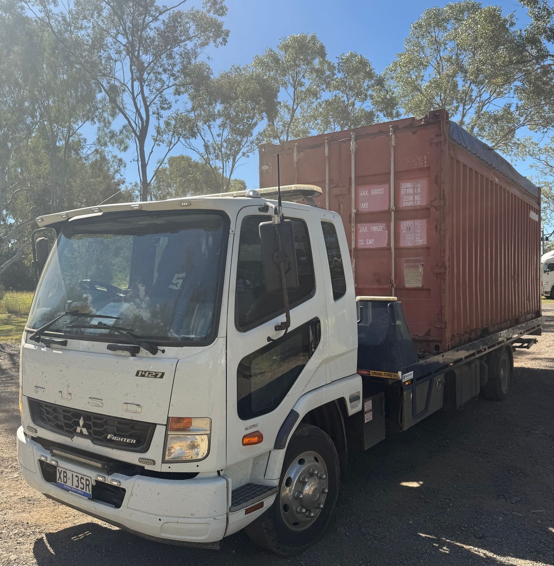 A Car Is Being Towed By A Tow Truck — Rockhampton Towing And Transport in Gracemere, QLD