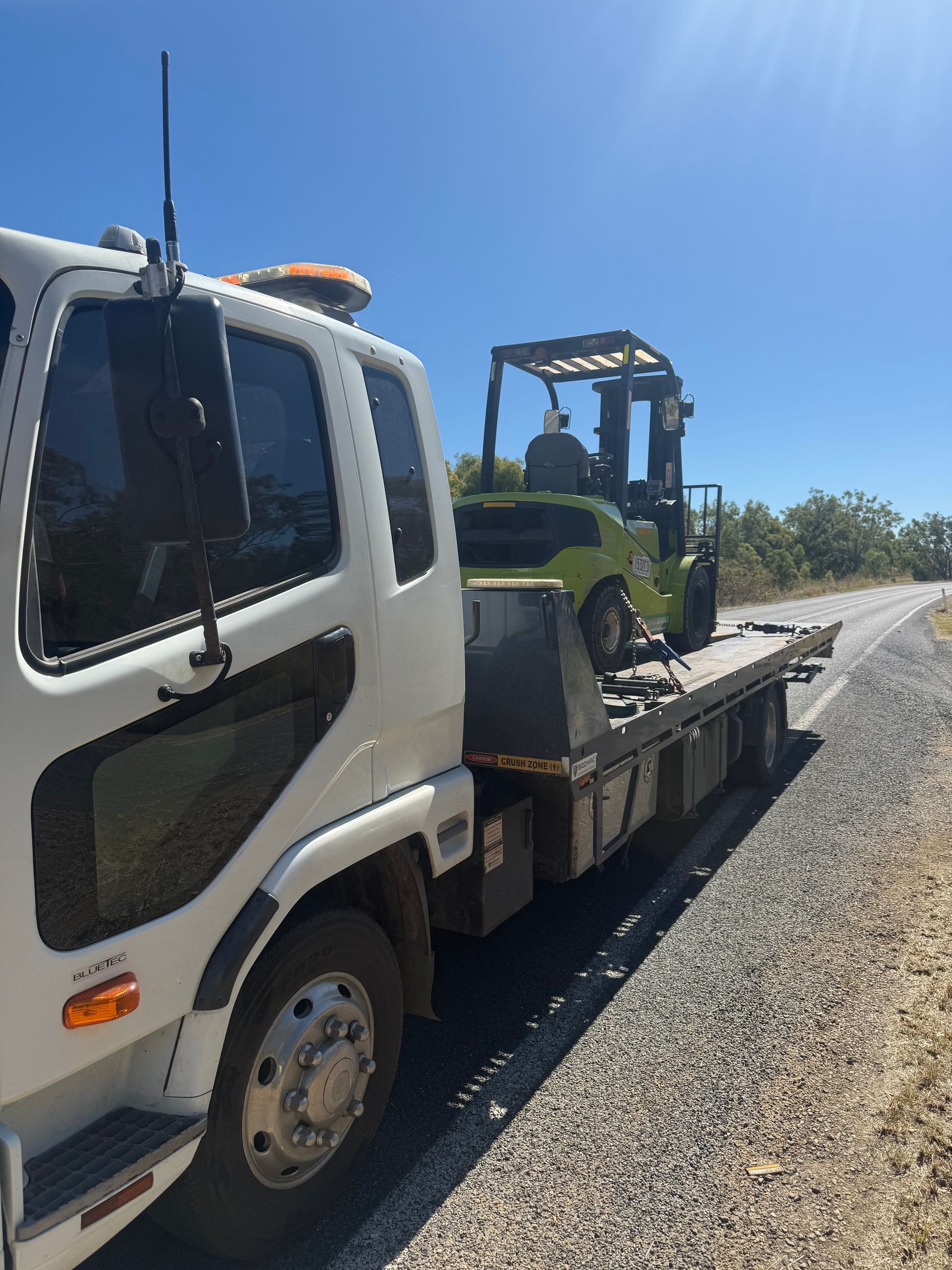 A Car Is Being Towed By A Tow Truck — Rockhampton Towing And Transport in Yeppoon, QLD
