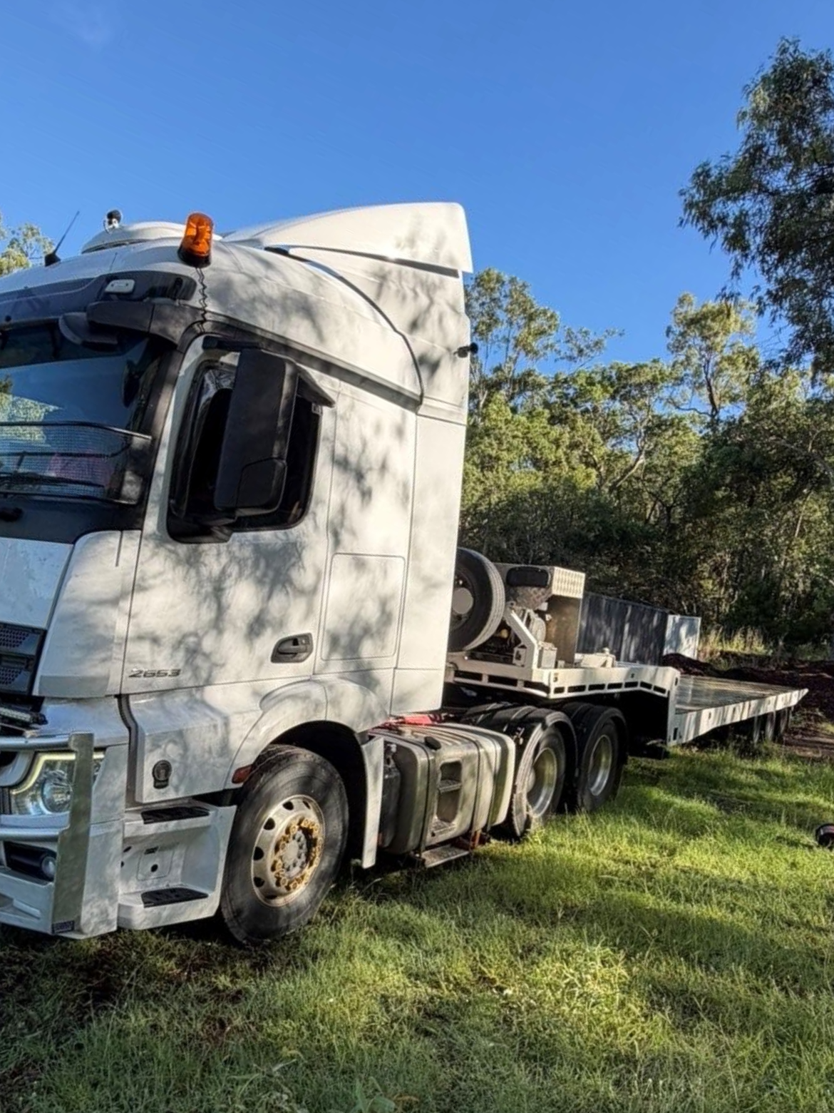 A Red Car Is Being Towed By A Tow Truck — Rockhampton Towing And Transport in Yeppoon, QLD