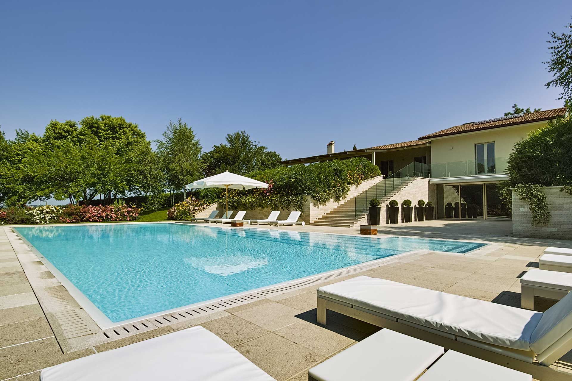 Swimming pool with lounge chairs in front