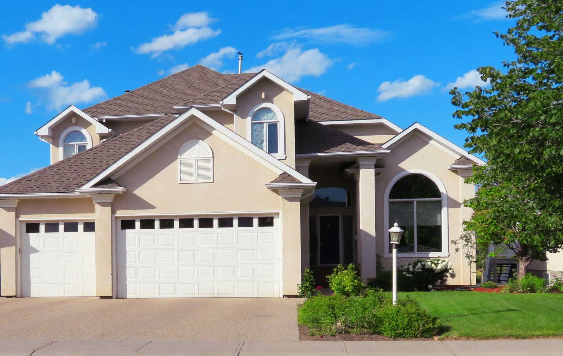 Beige two-story house with white trim
