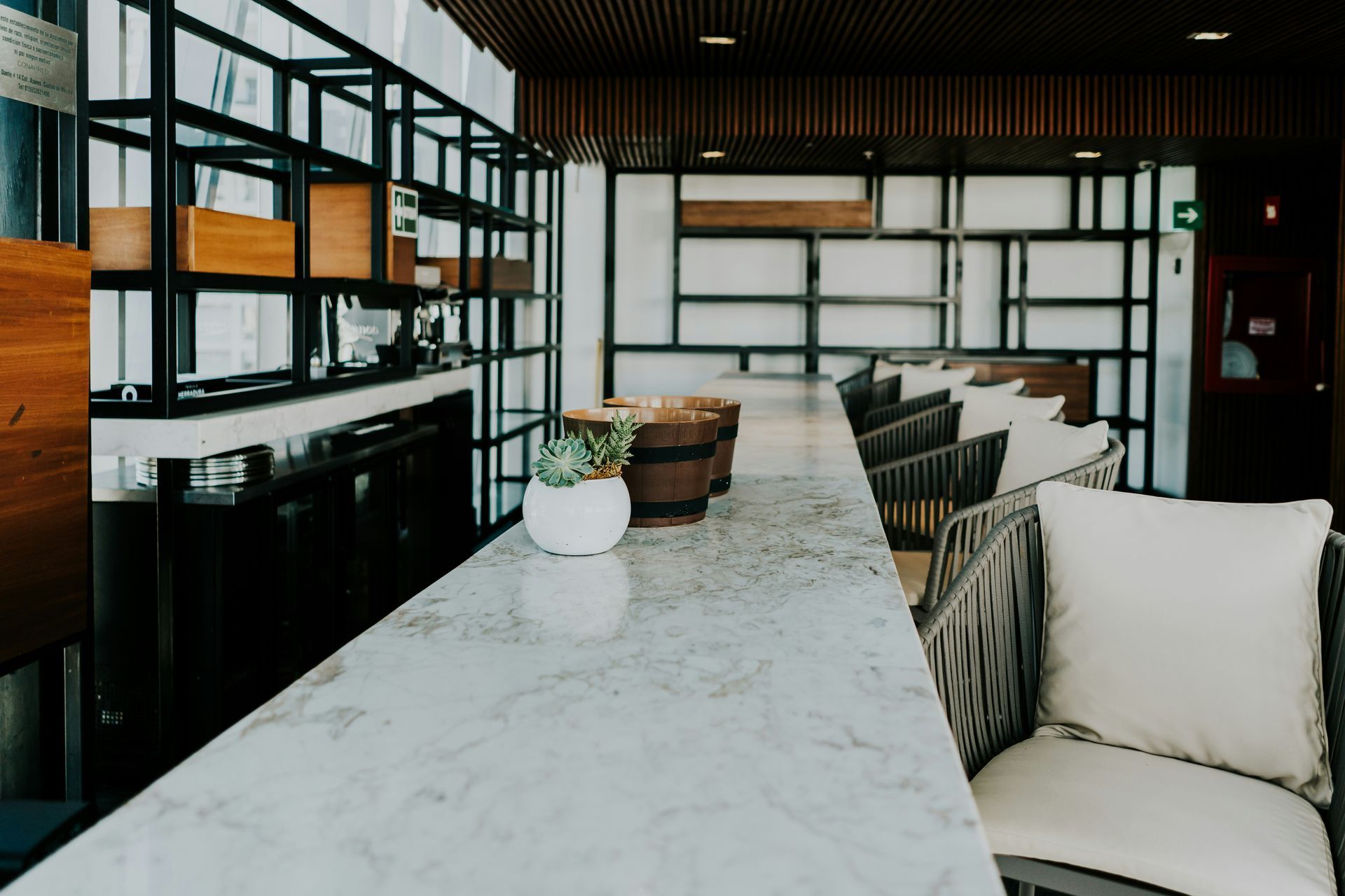 A room with a long table and chairs and a marble counter top.