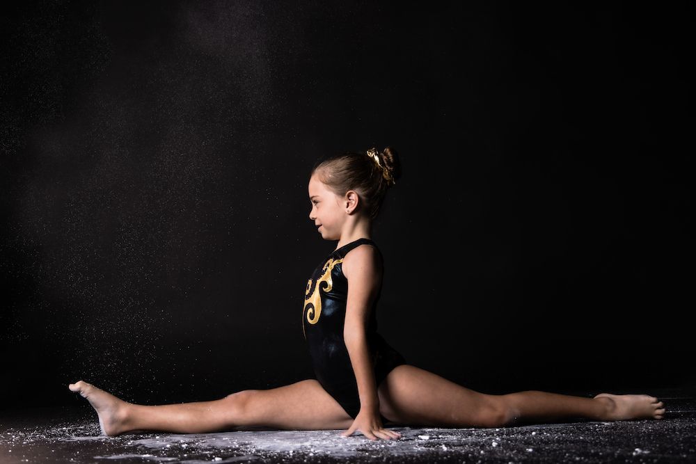 Young Gymnast Girl Splitting — Gold Medal Gymnastics In Molendinar, QLD