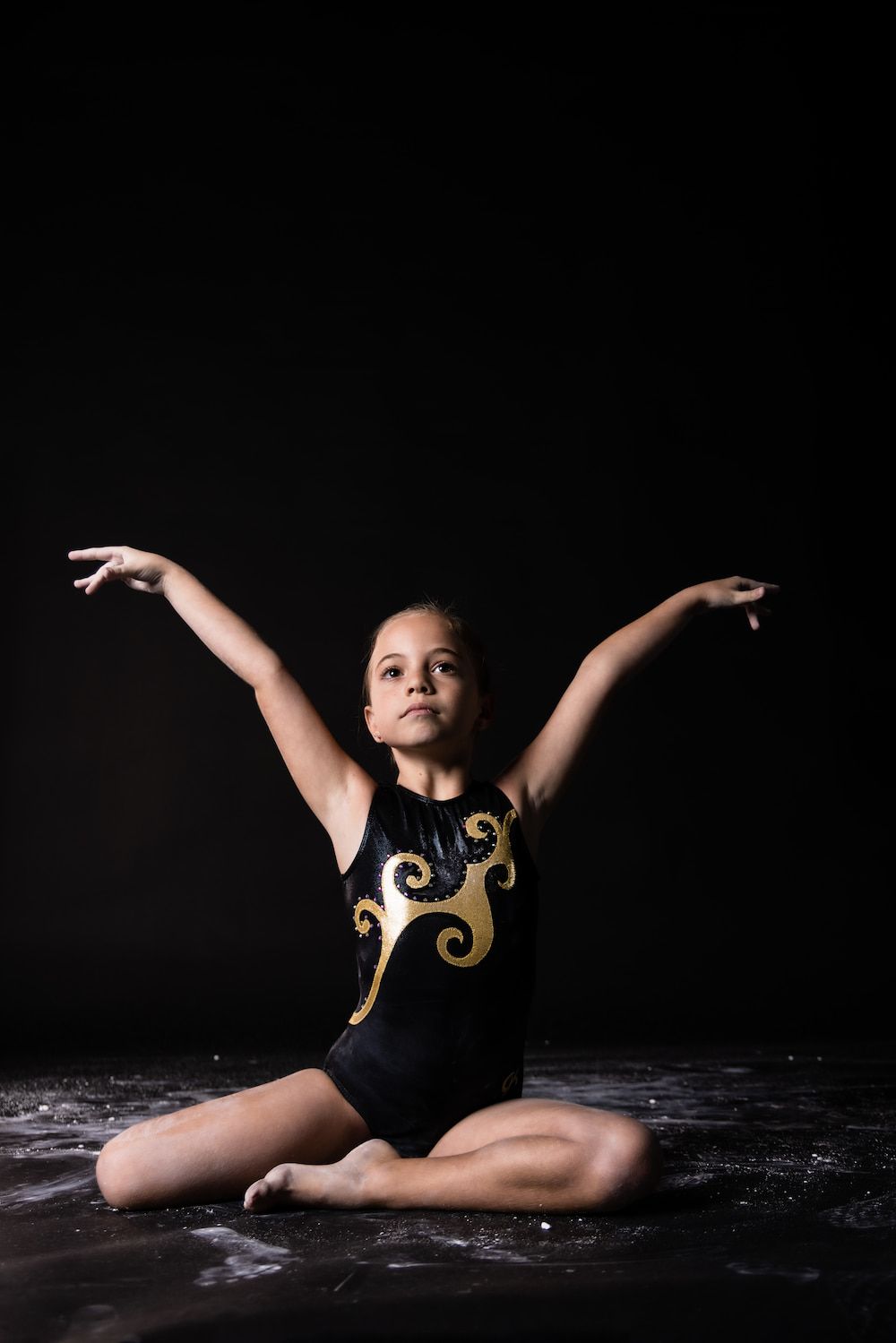 A Gymnast Girl Raising Hands — Gold Medal Gymnastics In Molendinar, QLD