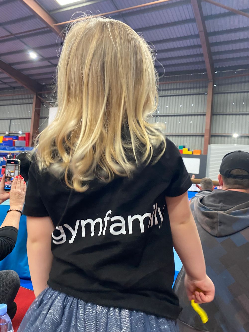 A Little Girl Wearing A Black T-shirt — Gold Medal Gymnastics In Molendinar, QLD