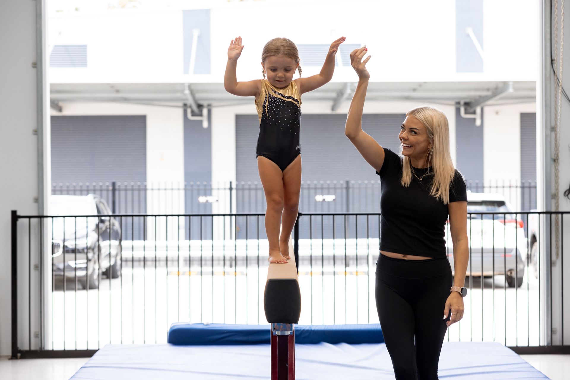A Man And Two Little Girls Are Playing With A Green Hula Hoop — Gold Medal Gymnastics In Molendinar, QLD