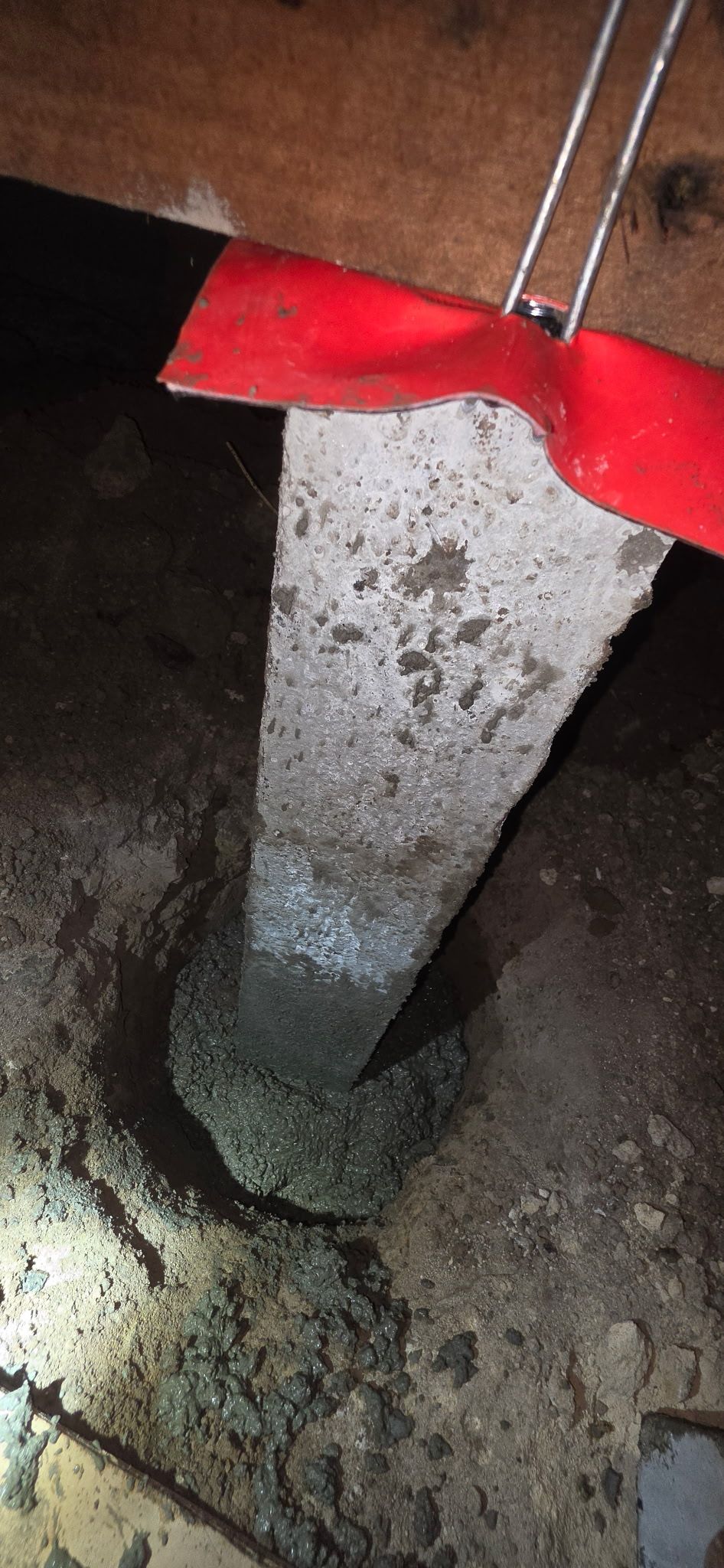 Cracked concrete beam and column interior with exposed ceiling damage in an unfinished building