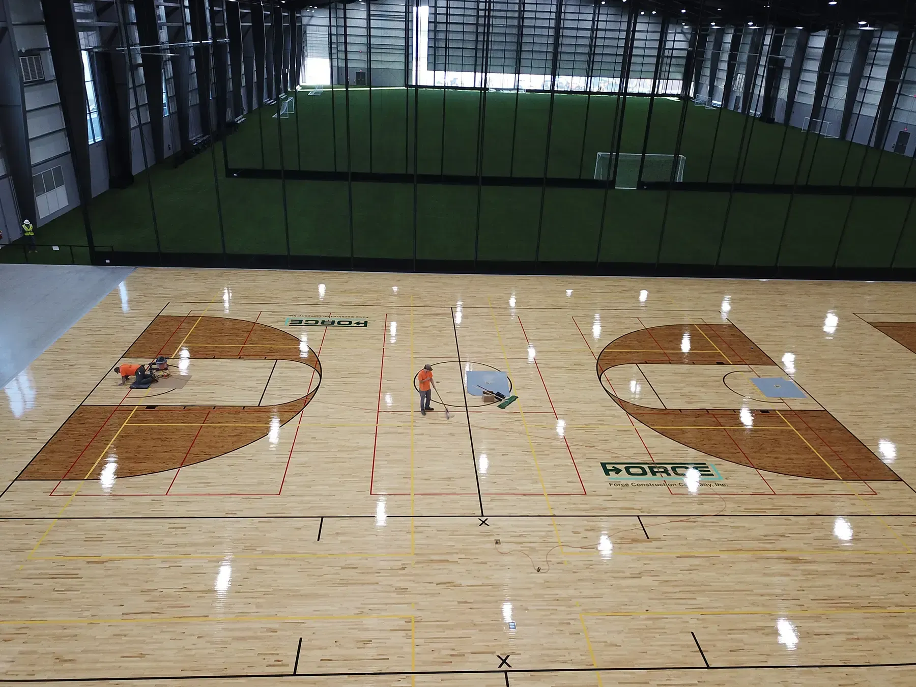 The Force Construction logo painted on basketball courts at the Circle-K Fieldshouse at NexusPark.