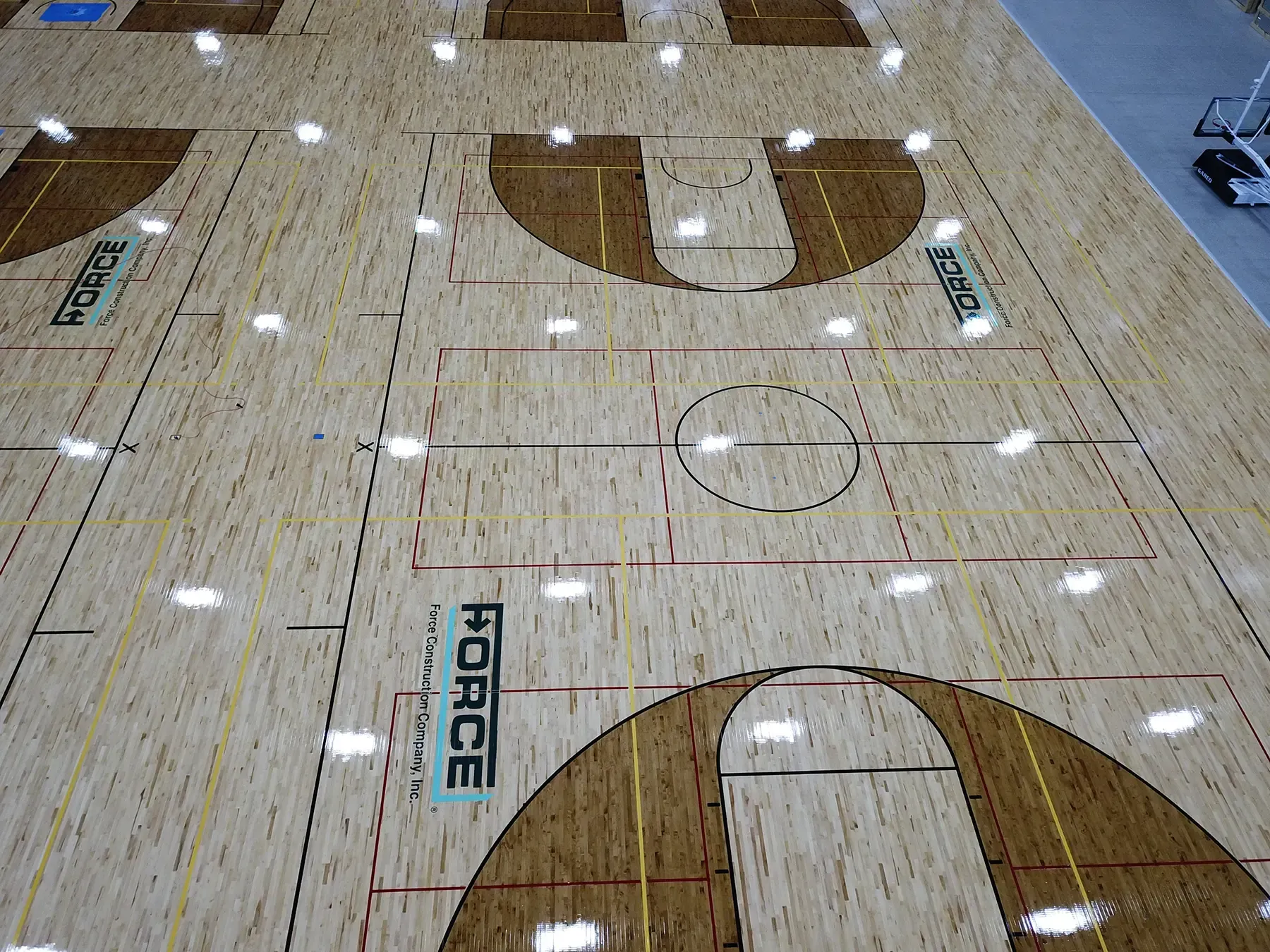 The Force Construction logo painted on basketball courts at the Circle-K Fieldshouse at NexusPark.