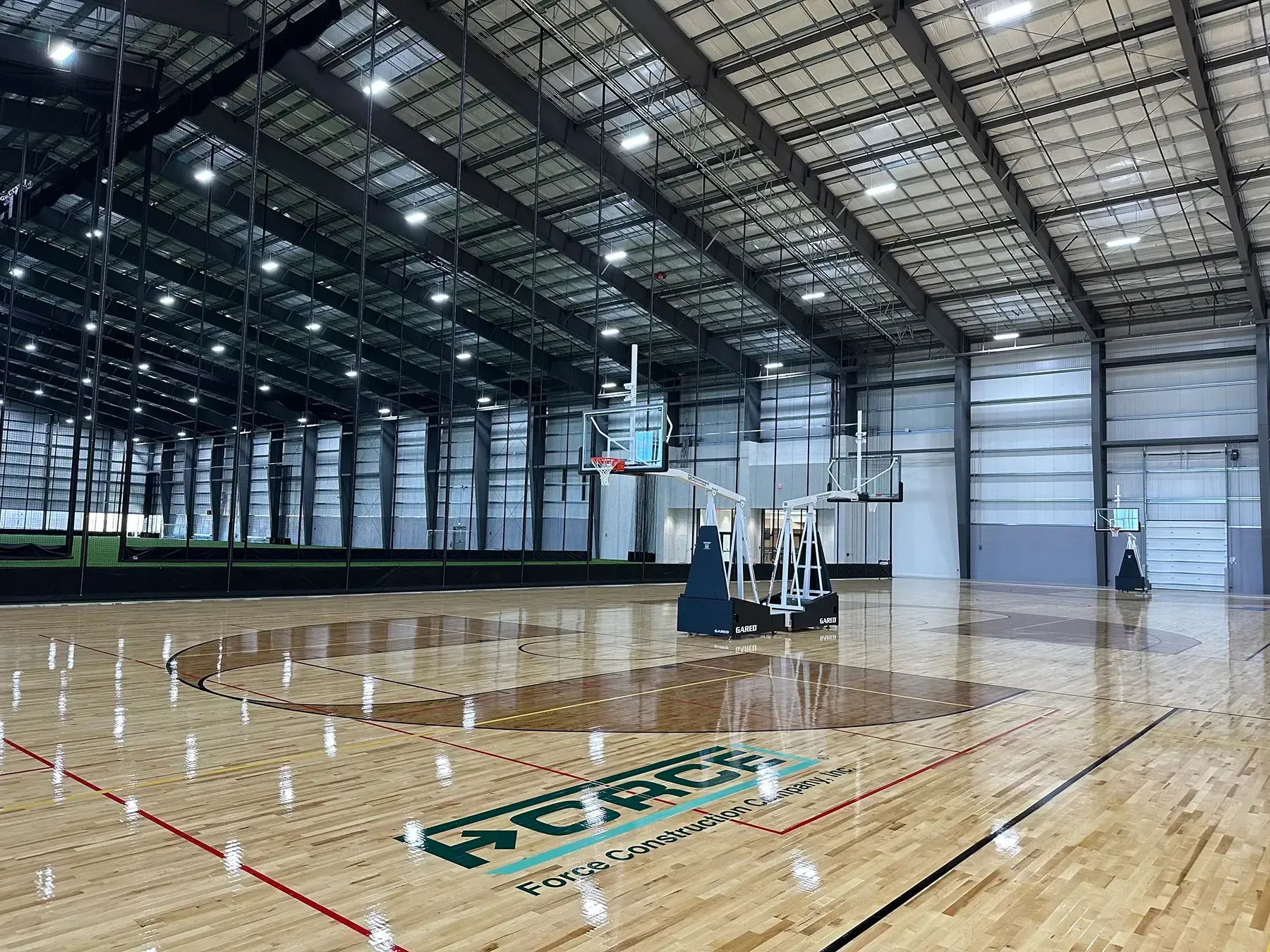 The Force Construction logo painted on basketball courts at the Circle-K Fieldshouse at NexusPark.