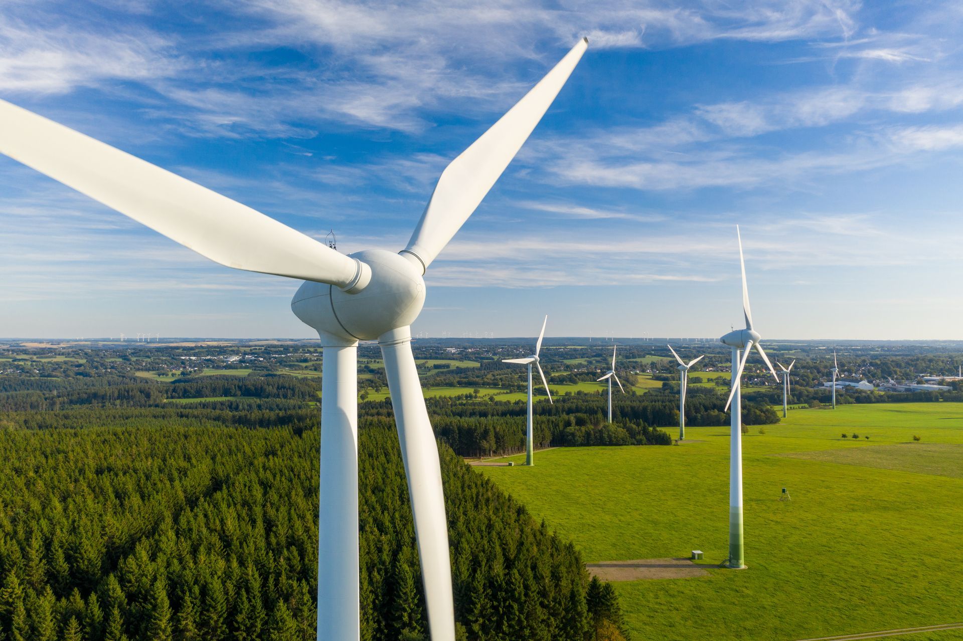 an aerial view of wind turbines in a field in New England