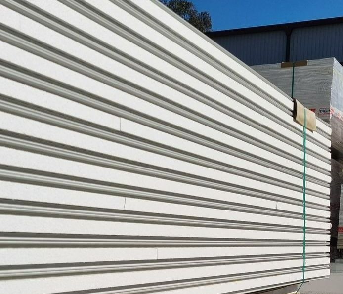 Stack of white corrugated metal panels.