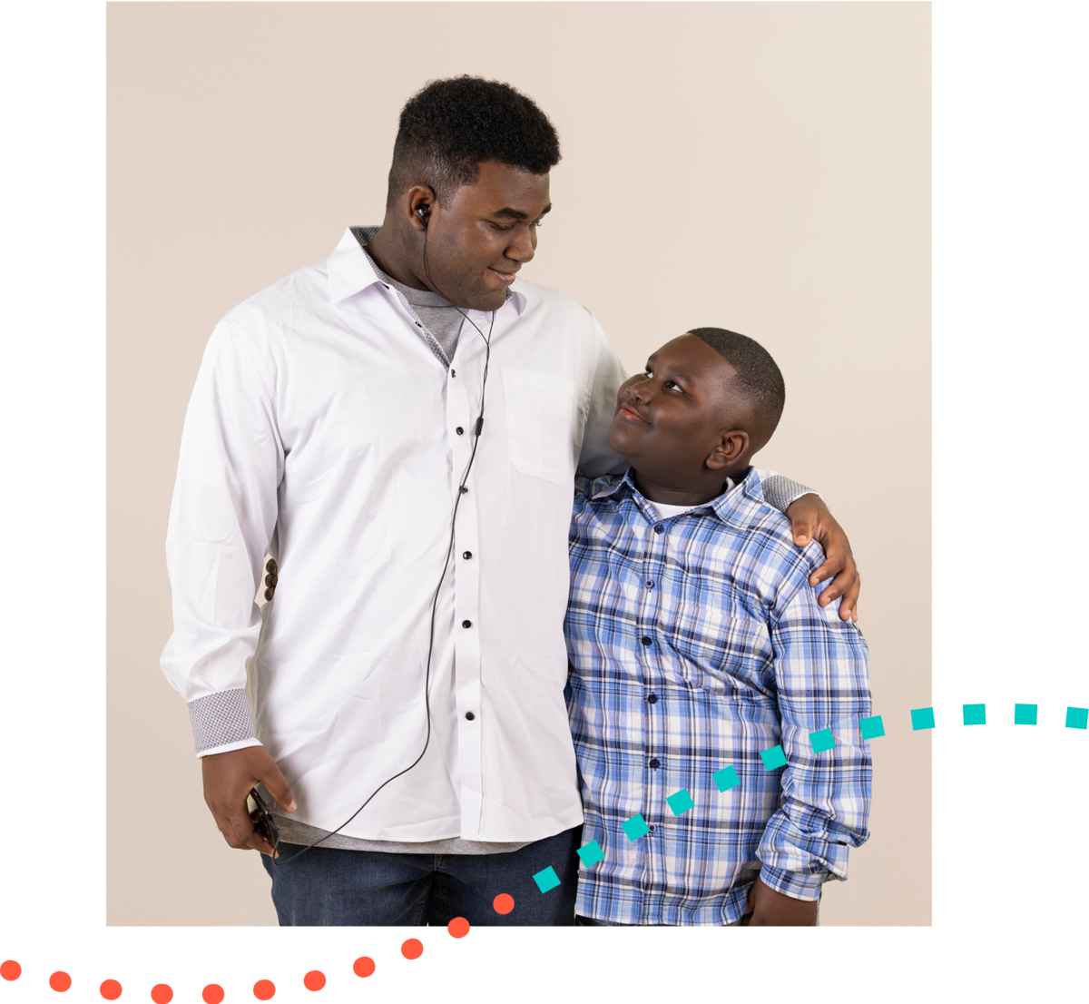 A man in a white shirt is standing next to a boy in a plaid shirt.