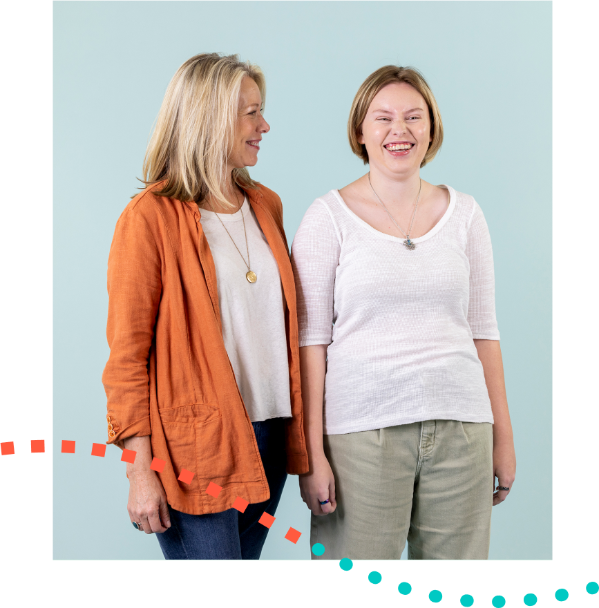 Two women are standing next to each other and smiling