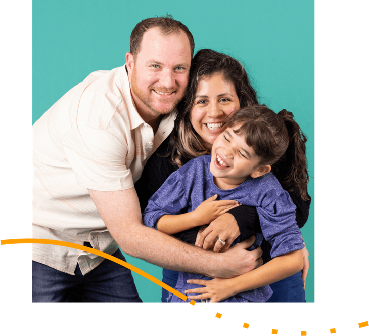 A man , woman and child are posing for a picture.