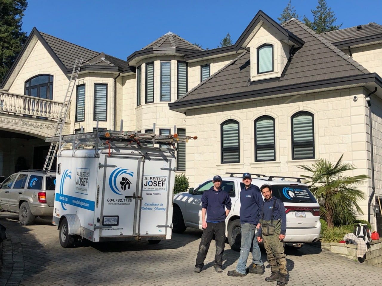 A group of men standing in front of a large house