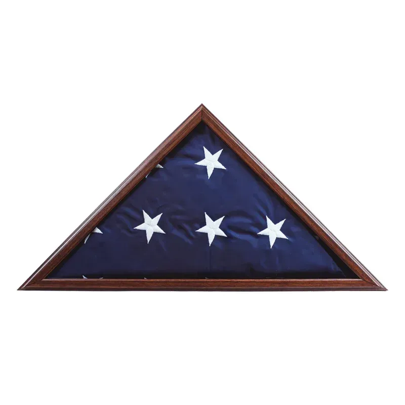 Folded American flag in a wooden display case on a white background