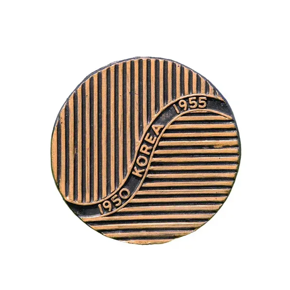 Copper-toned circular medal with black striped design and “1950 KOREA 1955” inscription