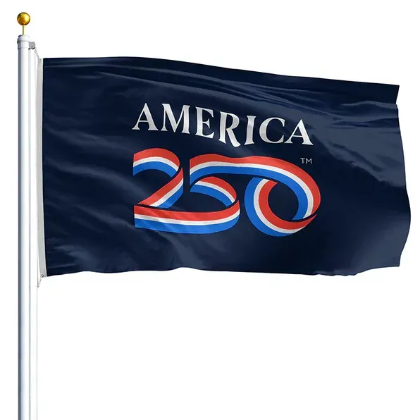 Dark blue flag with “AMERICA 250” in red, white, and blue, flying on a white flagpole.