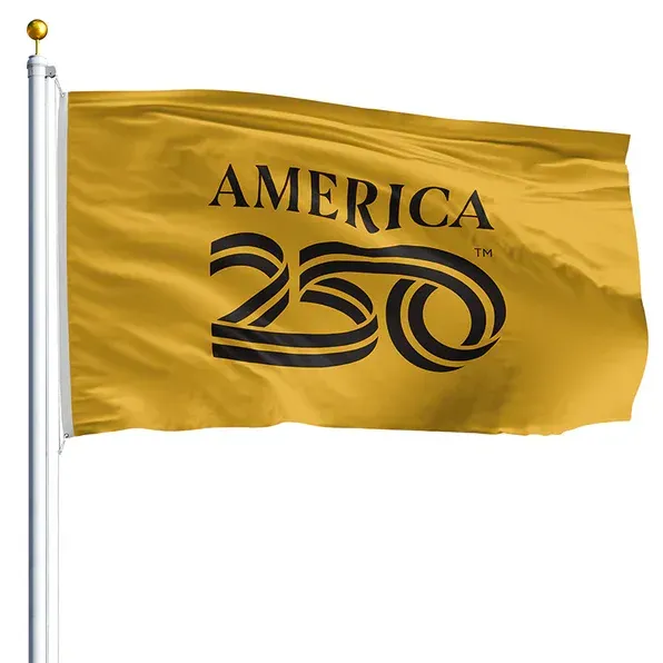 Gold flag with “AMERICA 250” logo waving on a flagpole against a white background