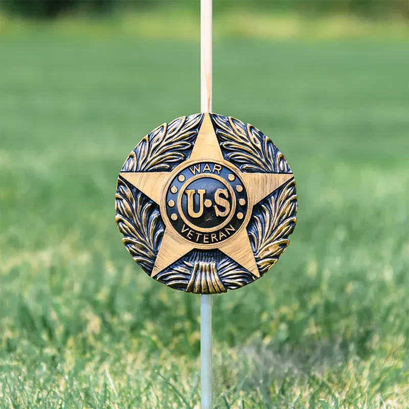Gold U.S. War Veterans medallion with a star and laurel wreath on a white background