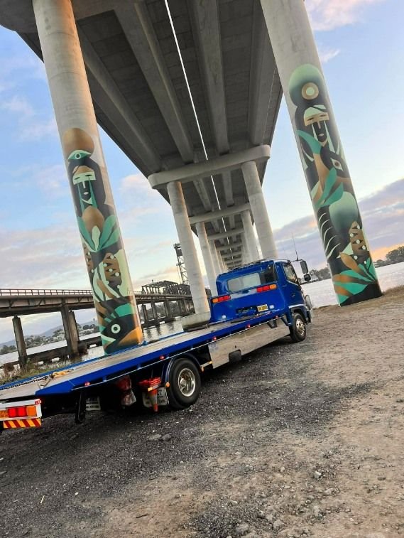 A Blue Tow Truck is Parked Under a Bridge — TNT Towing - Coffs Clarence in Coffs Harbour, NSW