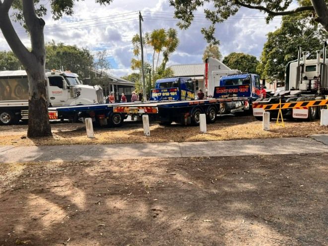 A Row of Trucks Are Parked on the Side of the Road — TNT Towing - Coffs Clarence in Woolgoolga, NSW