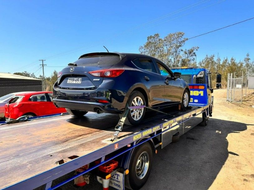 A Car is Being Towed by a Tow Truck — TNT Towing - Coffs Clarence in South Grafton, NSW