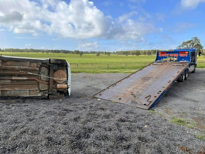 A Tow Truck is Towing a Car That Has Fallen Over — TNT Towing - Coffs Clarence in Iluka, NSW