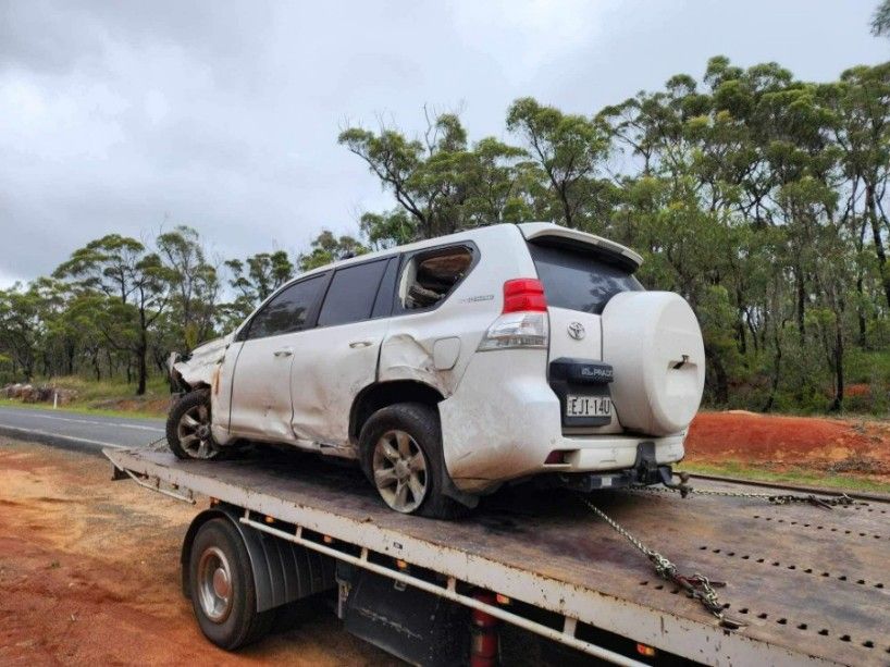A White SUV is Sitting on Top of a Tow Truck — TNT Towing - Coffs Clarence in Lismore, NSW