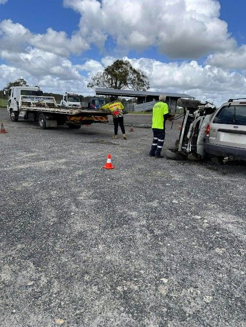 A Tow Truck is Towing a Car That Has Turned Over in a Gravel Lot — TNT Towing - Coffs Clarence in Ballina, NSW