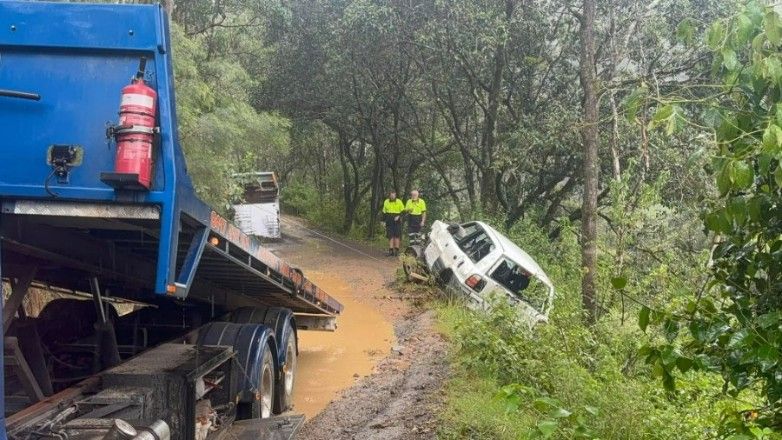 A Tow Truck is Towing a Car That Has Fallen Off the Road — TNT Towing - Coffs Clarence in Ballina, NSW