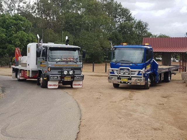Two Tow Trucks Are Parked Next to Each Other on the Side of the Road — TNT Towing - Coffs Clarence in South Grafton, NSW