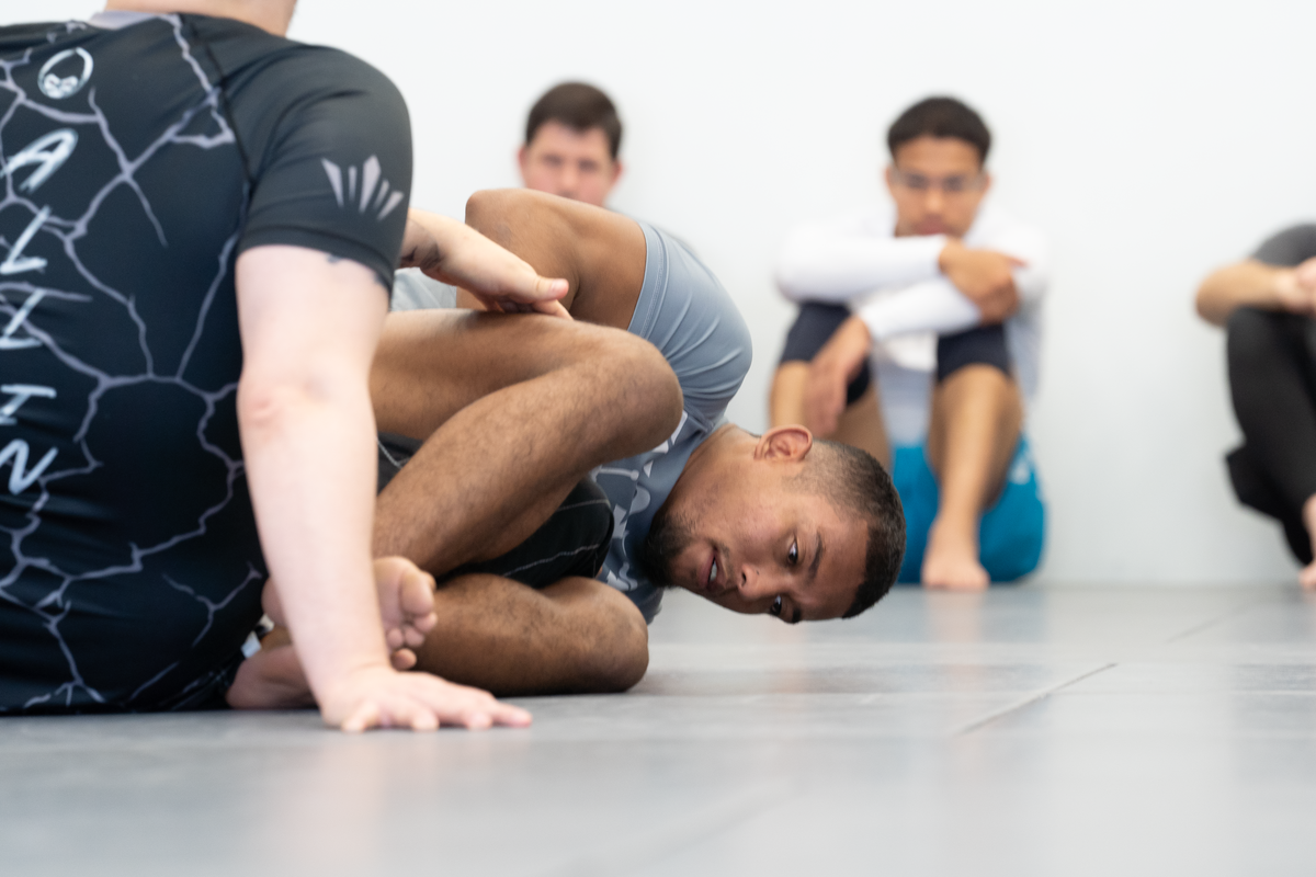 Adults drilling beginner jiu-jitsu techniques at All in Jiu-Jitsu in Green Brook, NJ.