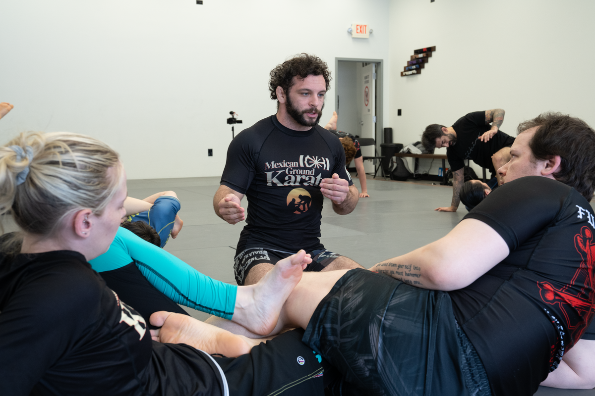 Adults drilling Brazilian Jiu-Jitsu technique at All in Jiu-Jitsu in Green Brook, NJ for strength and stress relief