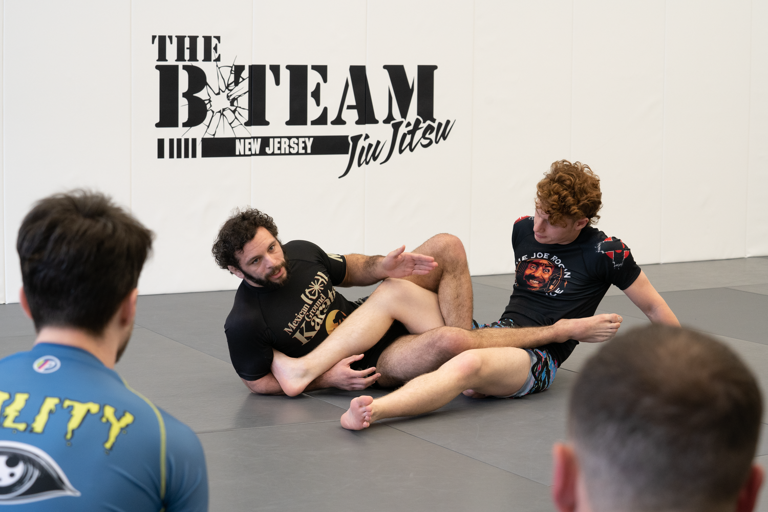 Adults practicing Brazilian Jiu-Jitsu drills at All in Jiu-Jitsu in Green Brook, NJ for fitness.